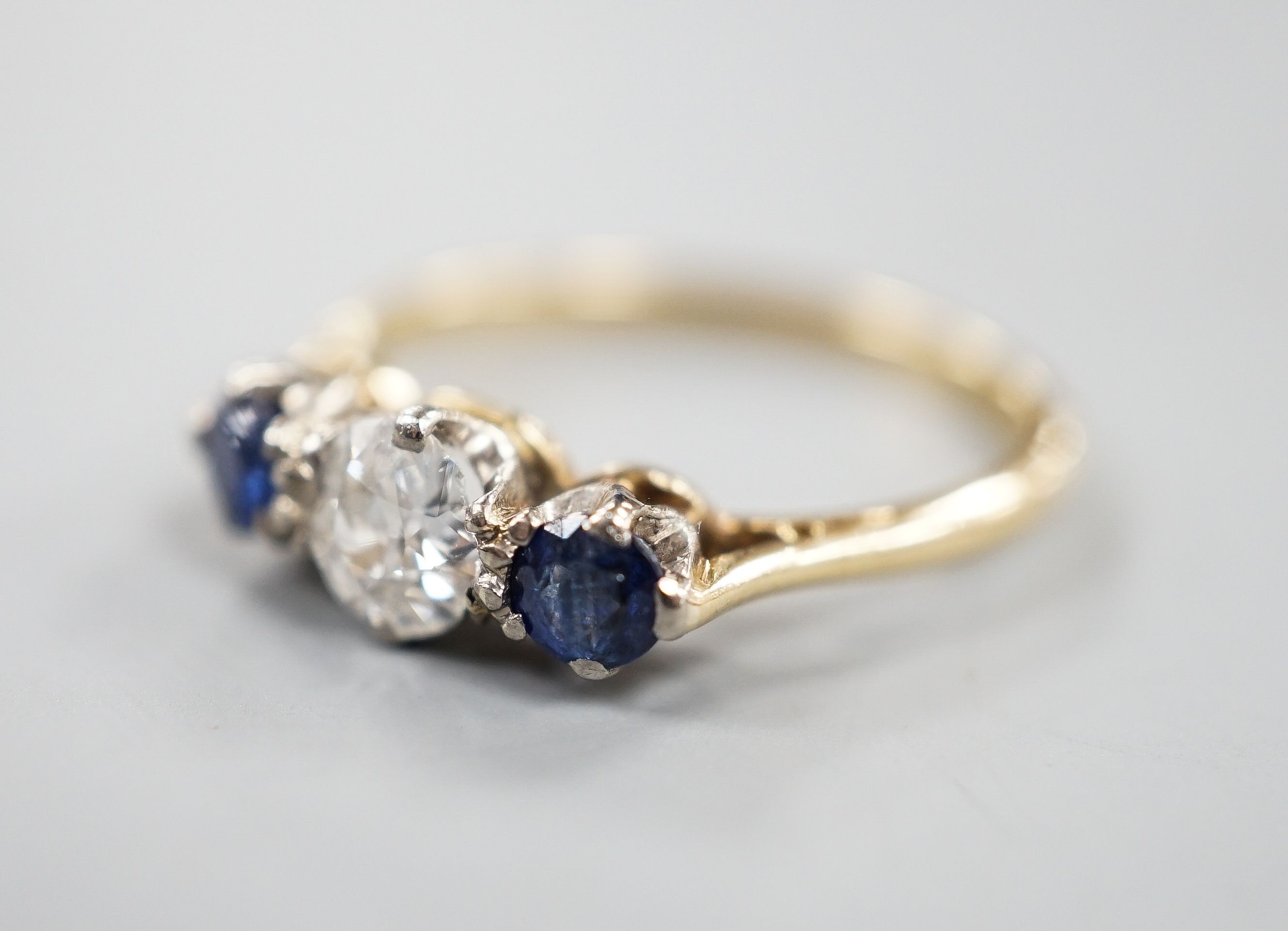 An 18ct & Plat, two stone sapphire and single stone diamond ring, size R, gross weight 3.1 grams.